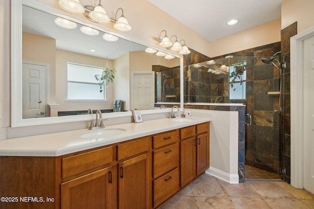 full bathroom with double vanity, a shower stall, and a sink