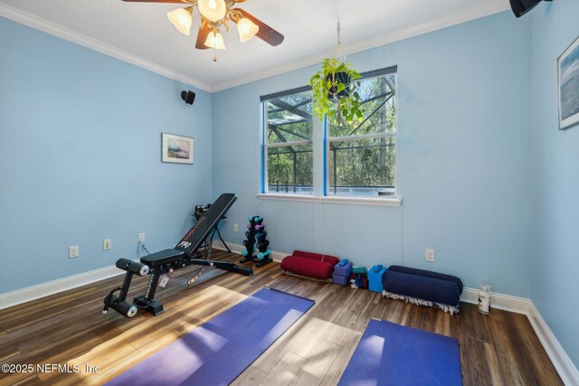 exercise room with baseboards and wood finished floors