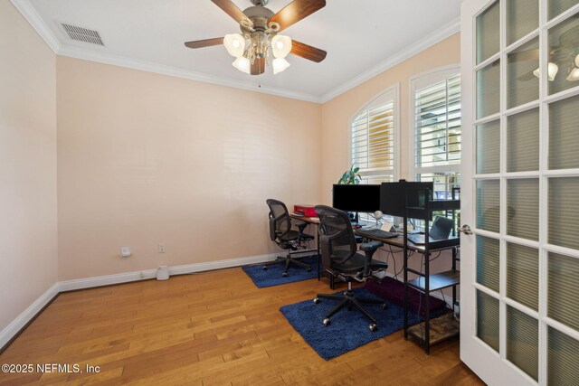 office with visible vents, crown molding, baseboards, and wood finished floors