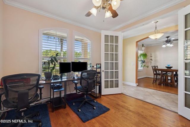 home office with crown molding, wood finished floors, and french doors