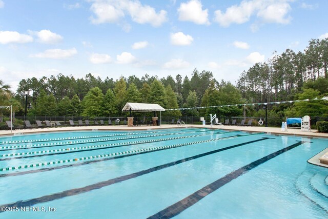 community pool featuring a patio and fence