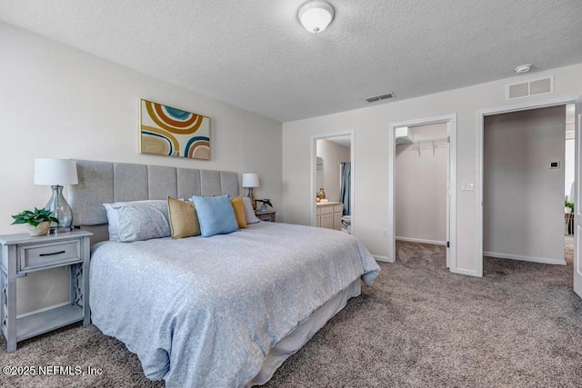 bedroom with ensuite bath, carpet, visible vents, and baseboards