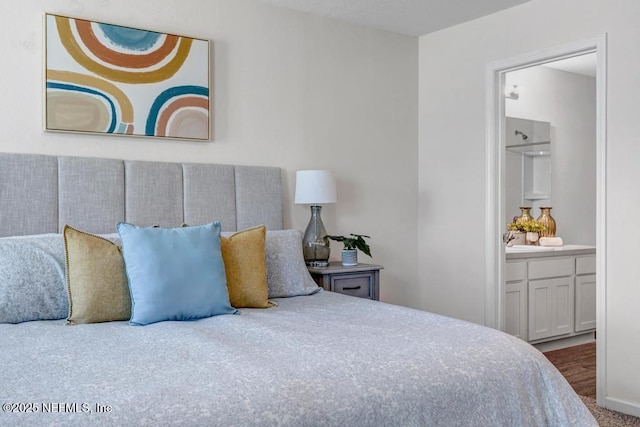 bedroom with baseboards and ensuite bathroom