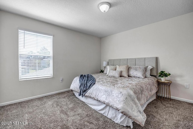 bedroom featuring baseboards, carpet floors, and a textured ceiling