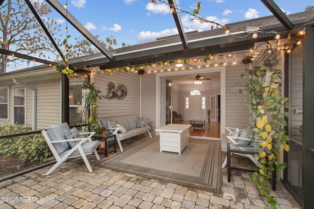 view of patio featuring glass enclosure and an outdoor hangout area