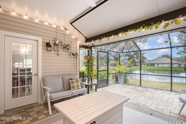 sunroom / solarium with a water view