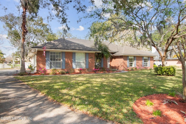 ranch-style house with brick siding and a front lawn