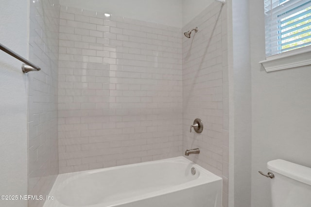 bathroom with toilet and bathtub / shower combination