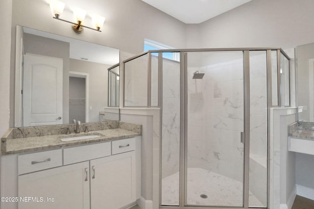 bathroom featuring a stall shower and vanity