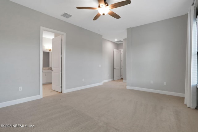 unfurnished bedroom with visible vents, baseboards, light carpet, and connected bathroom