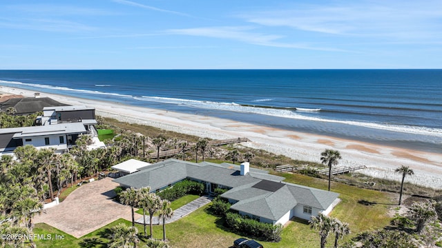 bird's eye view featuring a water view and a beach view