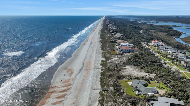 birds eye view of property featuring a beach view and a water view