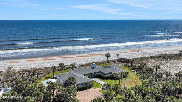 birds eye view of property featuring a beach view and a water view