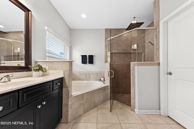 bathroom with vanity, tile patterned floors, a bath, and a shower stall