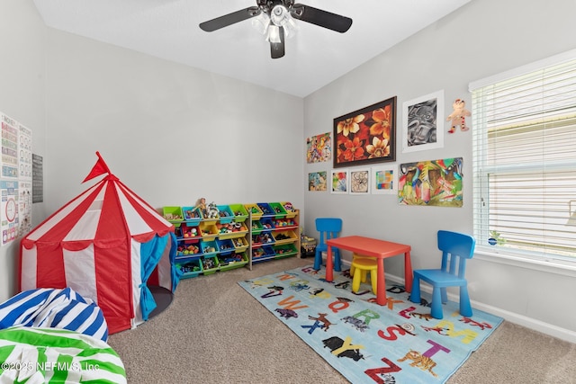 playroom with baseboards, a ceiling fan, and carpet flooring