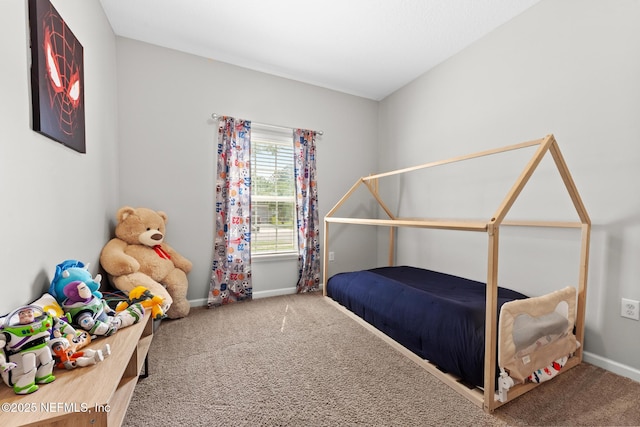 bedroom with baseboards and carpet