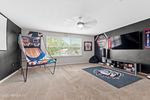 game room featuring carpet flooring, a ceiling fan, baseboards, and a textured ceiling