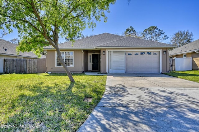 ranch-style house featuring a front yard, fence, and a garage