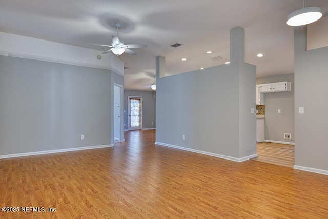 empty room featuring a ceiling fan, visible vents, baseboards, recessed lighting, and light wood-style floors