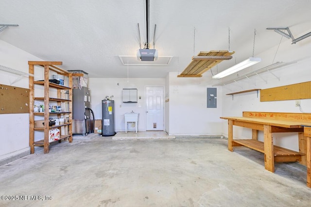 garage with electric panel, heating unit, electric water heater, a garage door opener, and a workshop area