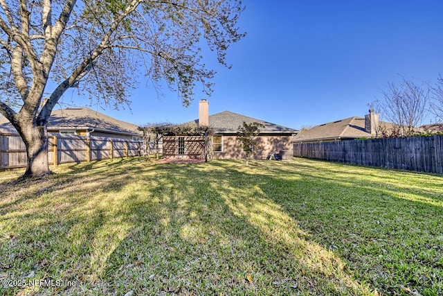 view of yard with a fenced backyard