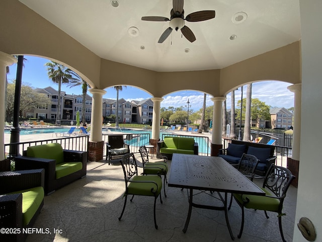 view of patio with outdoor dining space and a community pool