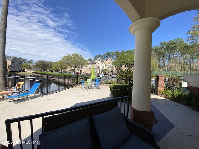 view of patio featuring outdoor dining space and fence