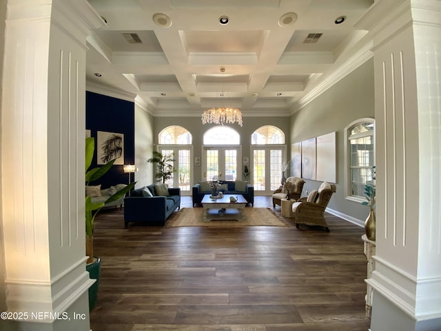 living area with visible vents, dark wood finished floors, an inviting chandelier, a towering ceiling, and beamed ceiling