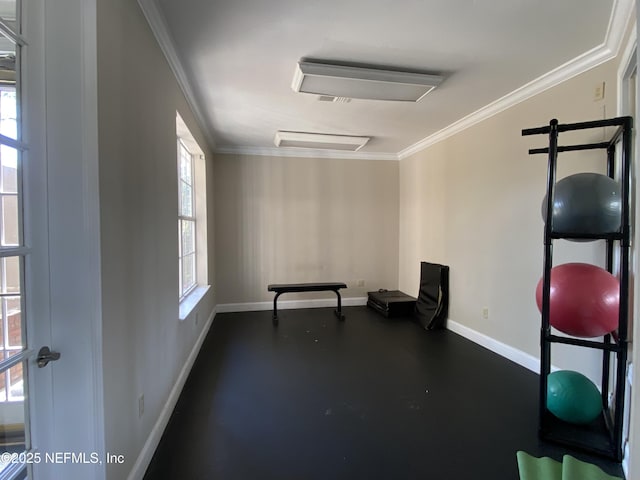 exercise area with baseboards and ornamental molding