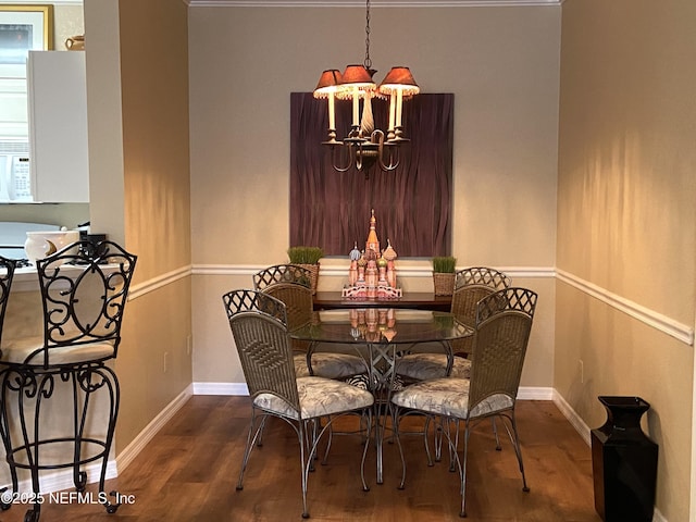 dining space featuring an inviting chandelier, wood finished floors, and baseboards