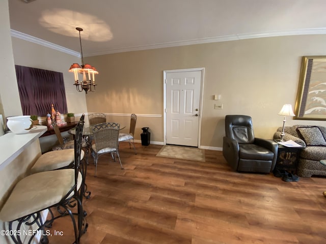 living room featuring a notable chandelier, crown molding, baseboards, and wood finished floors