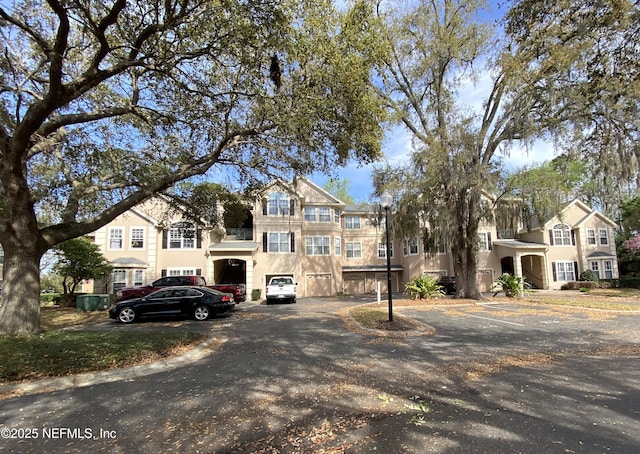 view of front of home with a garage and stucco siding