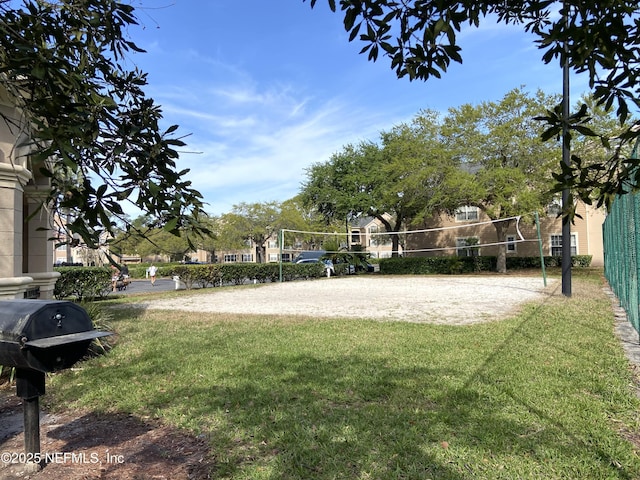 view of yard with fence and volleyball court