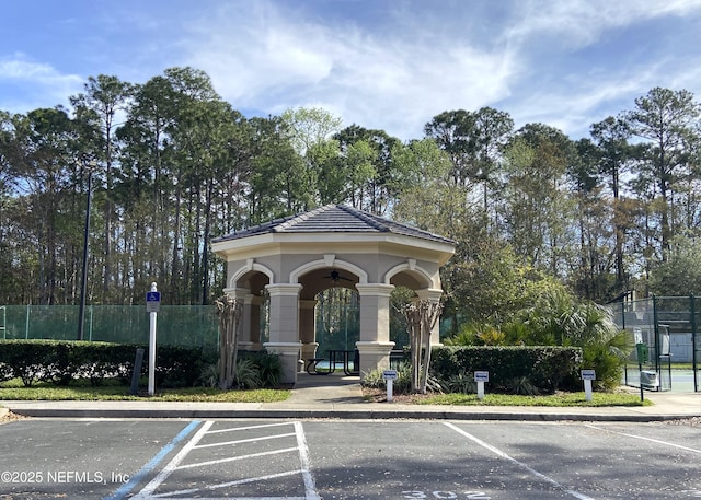 exterior space with uncovered parking and fence