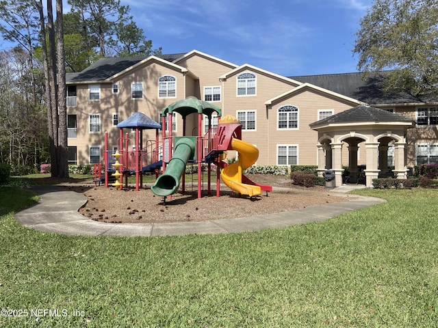 community jungle gym featuring a yard