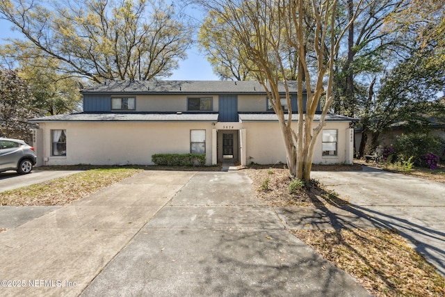 multi unit property featuring stucco siding and concrete driveway