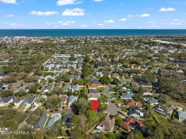 drone / aerial view with a residential view and a water view