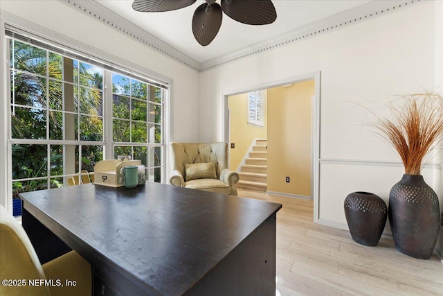 interior space with a ceiling fan, light wood-style floors, and baseboards