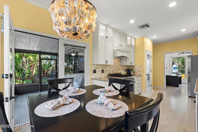 dining space with recessed lighting, visible vents, baseboards, and light wood-style floors