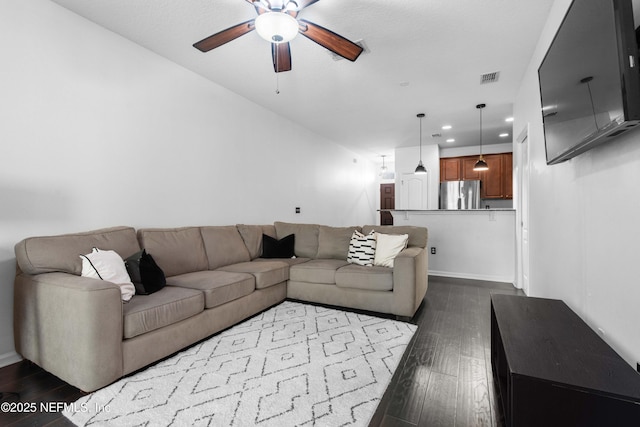 living room with a ceiling fan, visible vents, baseboards, recessed lighting, and dark wood-style flooring