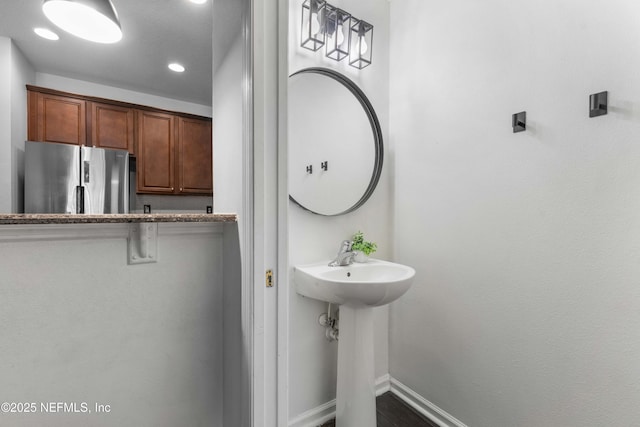 bathroom with recessed lighting and baseboards