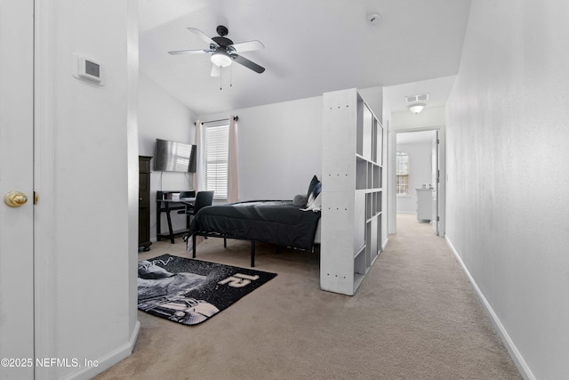 carpeted bedroom with vaulted ceiling, baseboards, visible vents, and ceiling fan