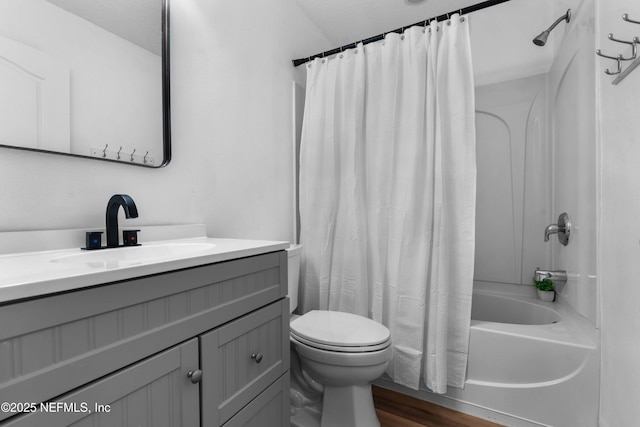 full bath featuring vanity, wood finished floors, toilet, and shower / bathtub combination with curtain