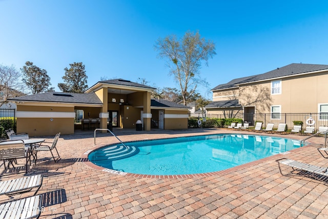 pool featuring a patio and fence