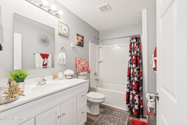 full bathroom featuring vanity, shower / bathtub combination with curtain, visible vents, a textured ceiling, and toilet