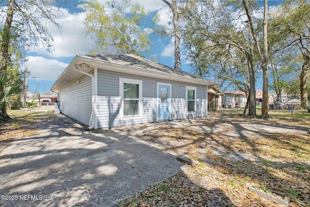 rear view of house featuring a patio area and fence