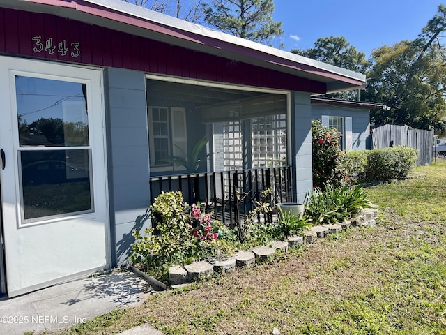 view of property exterior with mail area and fence