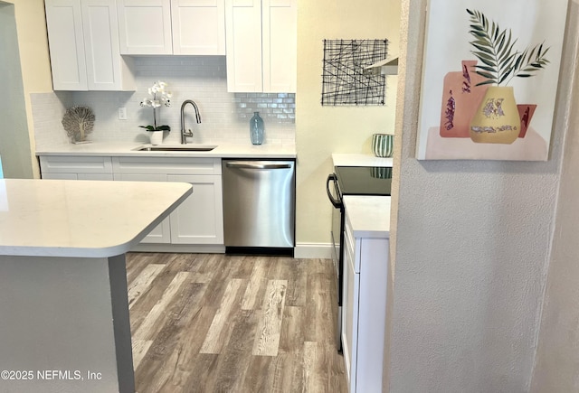 kitchen with dishwasher, light wood-type flooring, light countertops, and a sink