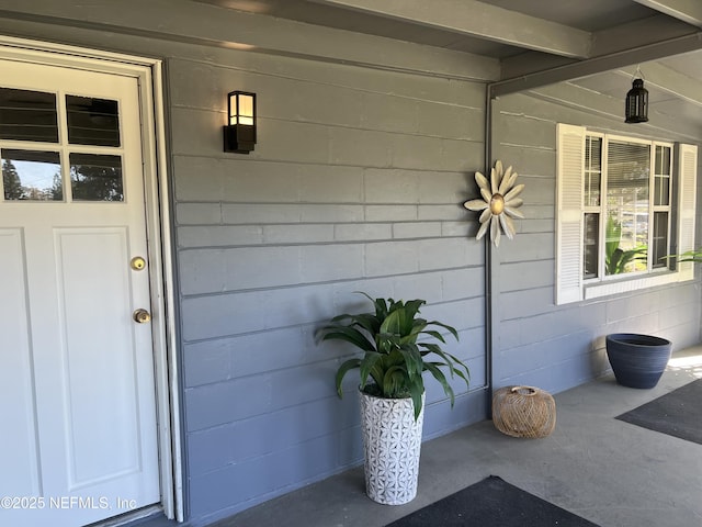 view of exterior entry with concrete block siding