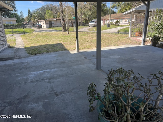 view of patio featuring a residential view and fence